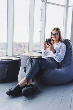 Happy smiling female manager using mobile phone gadget to check delivery serv Stock Photos