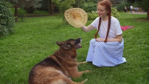Happy smiling ginger lady taking free time with her pet. Woman relaxing at Stock Footage 142510103