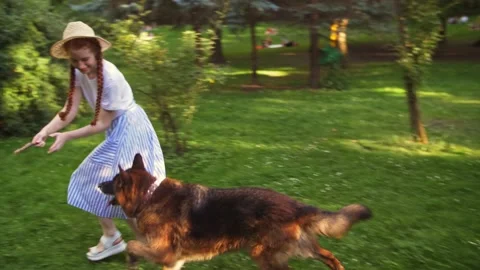 Happy smiling ginger lady taking free time with her big dog. Woman relaxing at Stock Footage 142513784