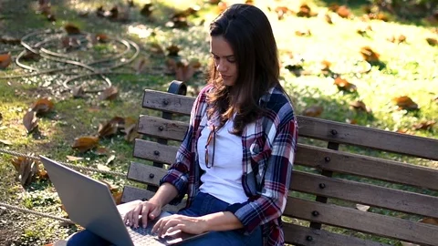 Happy smiling girl with computer in front of park panorama Stock Footage 101566418