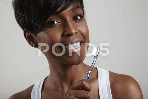 Happy smiling girl with a teeth brush Stock Photos