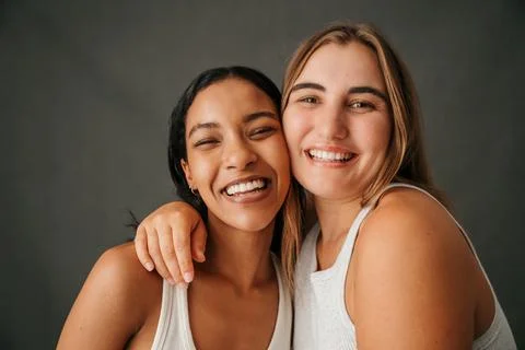 Happy smiling girlfriends in a studio posing Stock Photos