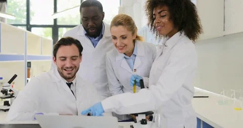 Happy Smiling Group Of Scientific Workers Looking At Laptop Computer Laugh Video stock 77222806