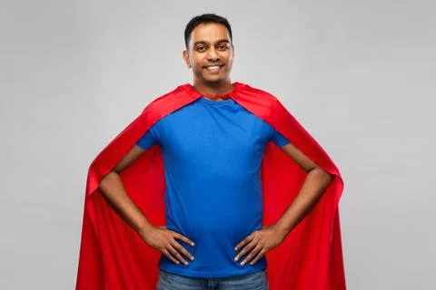Happy smiling indian man in red superhero cape Stock Photos