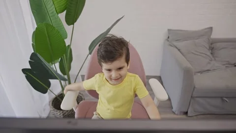 Happy smiling kid having fun watching cartoons at home Stock Footage 255815701