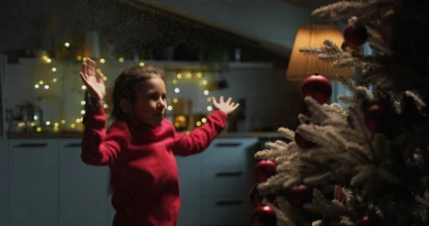 Happy smiling kid play with snow spray, cute girl jumping laughing Stock Footage 294516852