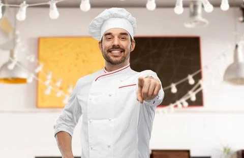 Happy smiling male chef in toque pointing to you Stock Photos