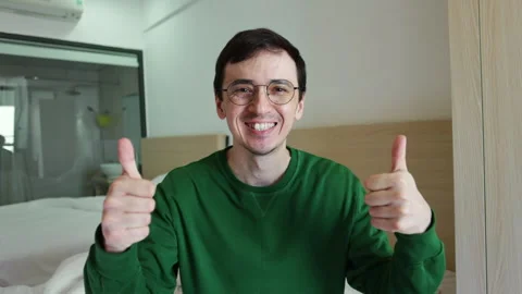 Happy smiling man giving two thumbs up gesture Video stock 337365824