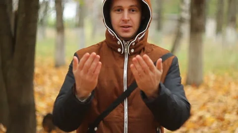 Happy smiling man in a jacket, presenting and showing something Stock Footage 68747968