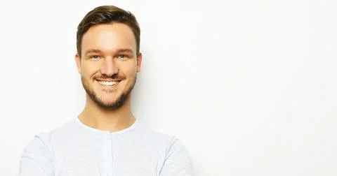 Happy smiling man looking at camera on white background Stock Photos