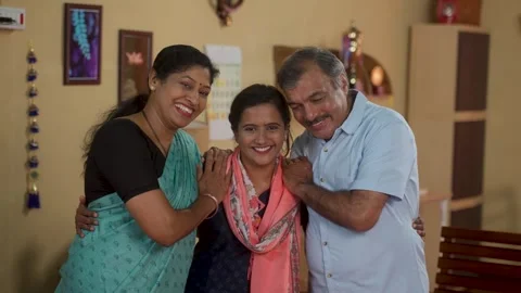 Happy smiling Middle class parents with daughter looking camera at home - Stock Footage 255013454