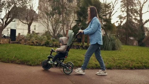 Happy smiling mom is taking her son on a trocheoli bicycle Video stock 296180991