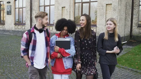 Happy Smiling Students walking an the Campus of a College Stock Footage 99364196