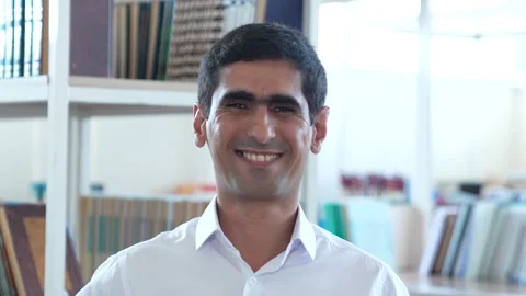 Happy smiling teacher in the library Video stock 244949516