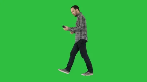 Happy smiling walking handsome bearded young man making selfie on a Green Screen Stock Footage