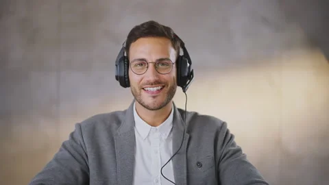 Happy smiling young man looking at camera and speaking. Agreeing with client Stock Footage 164487536