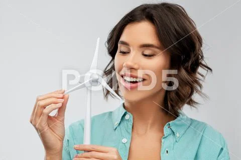Happy smiling young woman with toy wind turbine Stock Photos