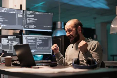 Happy software developer celebrating coding achievement Stock Photos
