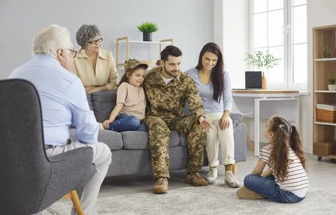 Happy soldier has fun and communicates with his family during his military Stock Photos