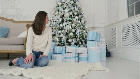 Happy son choosing Xmas present to unwrap with his mother Stock Footage 70869746