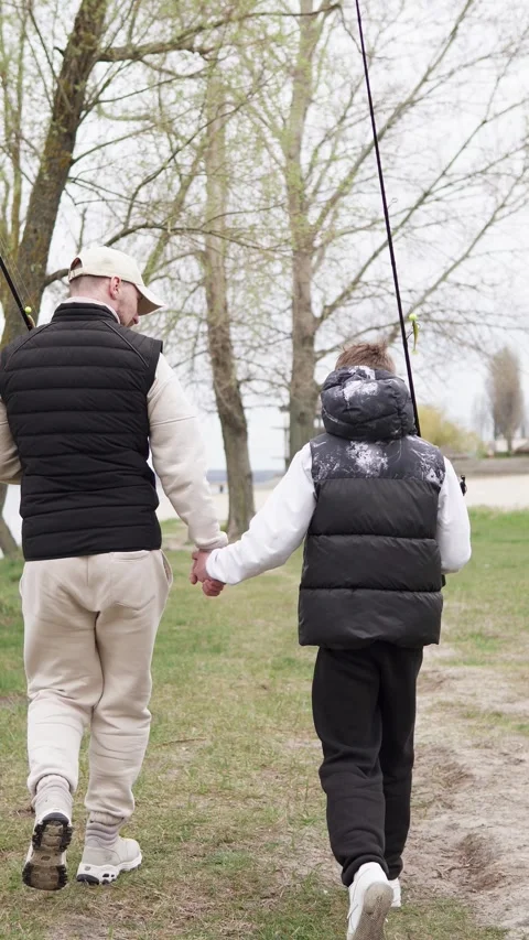 Happy son with dad goes to the river to fish. Father's Day with a child fishing. Stock Footage 308390974