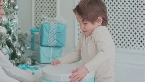Happy son opening a present with his mother Stock Footage 70376729