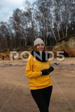 Happy sport and fashion lover enthusiast working out on a beach wearing bright Stock Photos