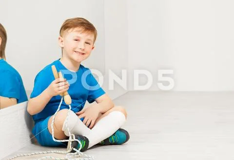 Happy sporty boy with jumping rope in gym Stock Photos