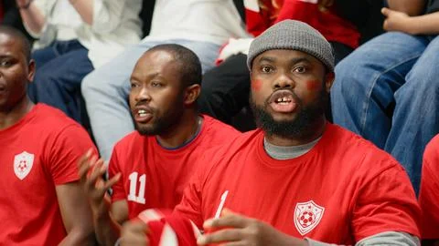 Happy stadium crowd celebrating decisive winning goal during the final minutes Stock Photos