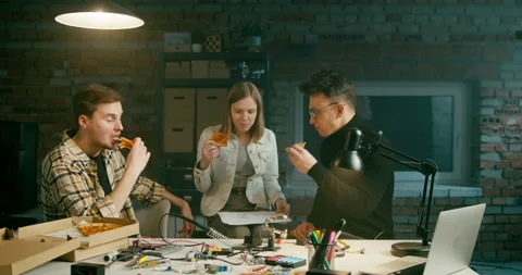 Happy Startup Workers Team Eat Pizza and Lough at Lunch Break in Loft Office Stock Footage