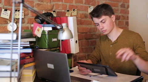 Happy student browsing internet on ipad at home Stock-Footage 40974357