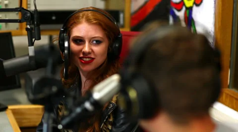 Happy student interviewing someone for radio in the studio Stock Footage