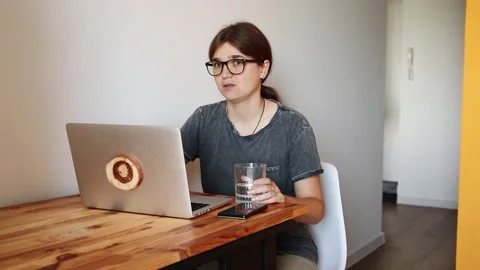 Happy Student Taking Online Classes. A Young Woman on a Laptop. Hello from .. Stock Footage 315508145