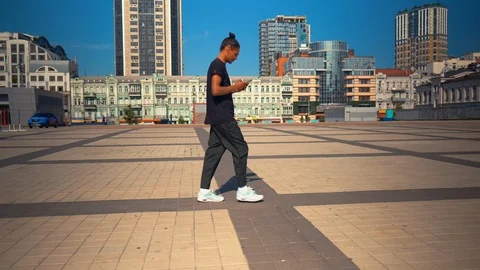 Happy student using mobile phone walk in modern city Stock Footage 112968849