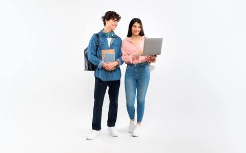 Happy Students Couple Using Laptop Studying On White Background Stock Photos