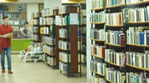 Happy students group in school library selecting books to read and walking Stock Footage 68569291