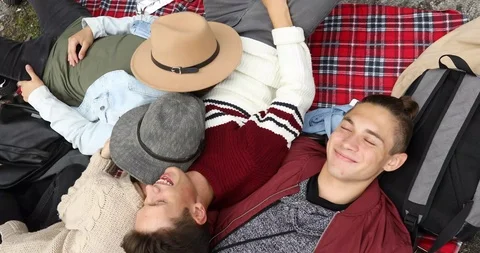 Happy students lying on ground and smiling Stock Footage 94437556