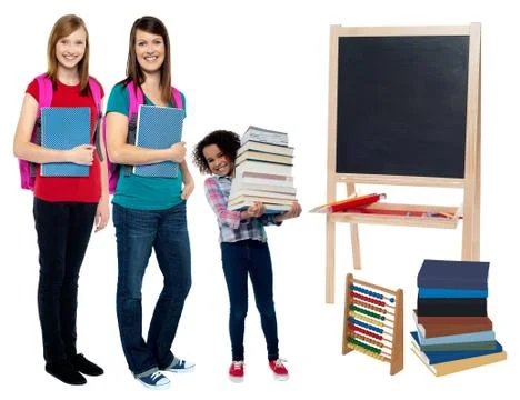 Happy students standing in classroom Stock Photos