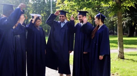 Happy students throwing mortar boards up Stock Footage 68860711