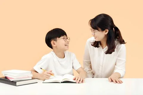Happy study time A child learning with a teacher or mother smiling brightly 写真素材
