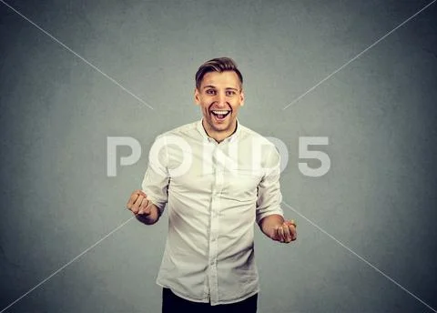 Happy successful business man winning fists pumped celebrating success Stock Photos