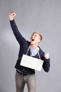 Happy successful man presenting empty signboard. Foto stock