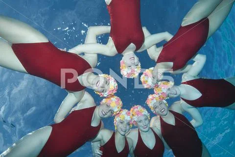 Happy Synchronized Swimmers Performing In Pool Stock Photos