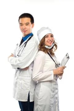 Happy team of two physicians standing back to back with arms folded isolated  Stock Photos