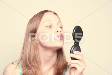 Happy teen girl looking at the mirror Stock Photos