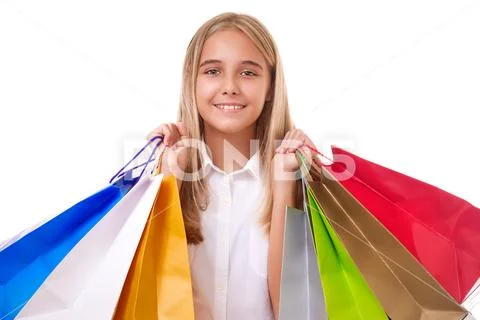 Happy teenage girl in casual clothing with shopping bags, isolated Stock Photos