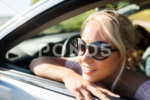Happy teenage girl or young woman in car Stock Photos
