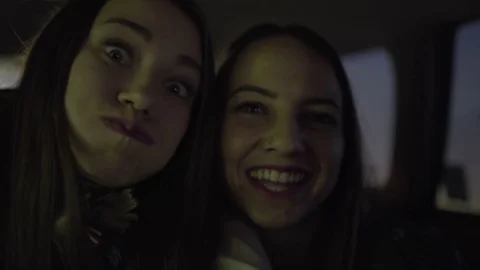 Happy Teens Use Camera Like A Smart Phone To Take Selfies, In Car At Night Stock Footage