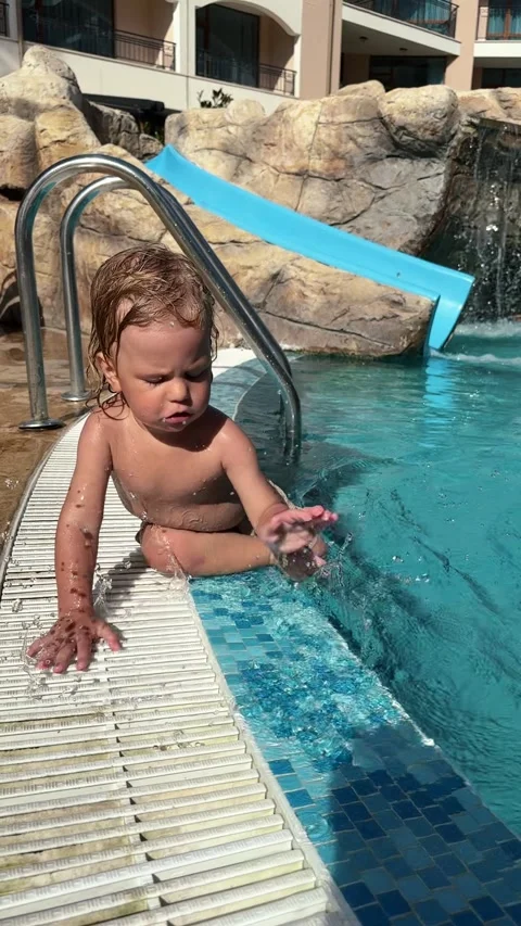 Happy Toddler Having Fun by the Poolside at a Sunny Resort Stock Footage 307722354