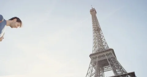 Happy tourist couple looking up at Eiffel Tower sightseeing enjoying European Stock Footage 73337868